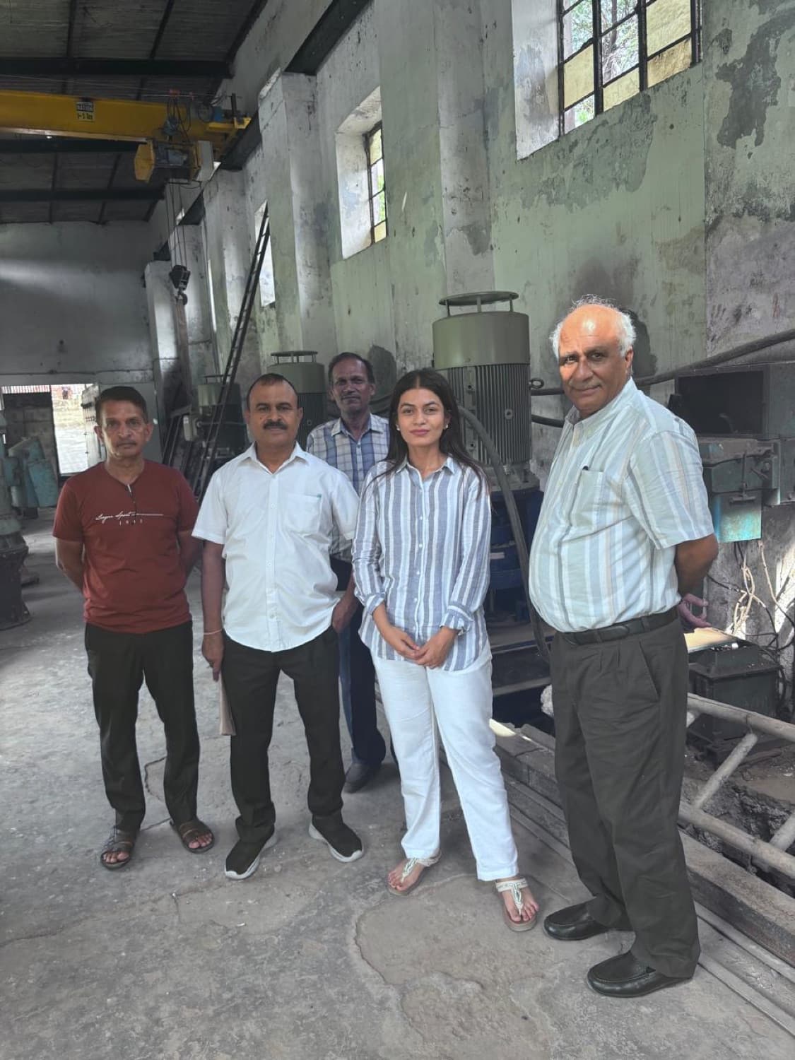 Avon Enterprises team at an installation site with an overhead crane